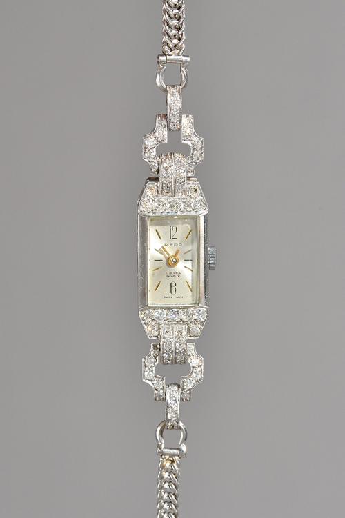 A Mepa platinum cased and diamond set lady's dress wristwatch, with a Swiss jewelled lever movement, the silvered dial with baton numerals, Arabic at