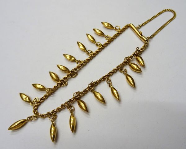 An Egyptian gold ropetwist link bracelet, fitted with pendant drops on a cylindrical clasp, gross weight 10.2 gms.