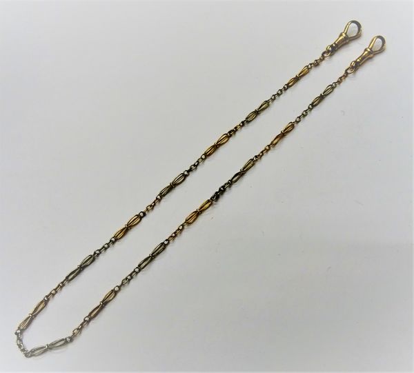 A two colour gold dress Albert chain, in an entwined and oval link design, fitted with two swivels, one detailed 18 CT, the other detailed 9C, length