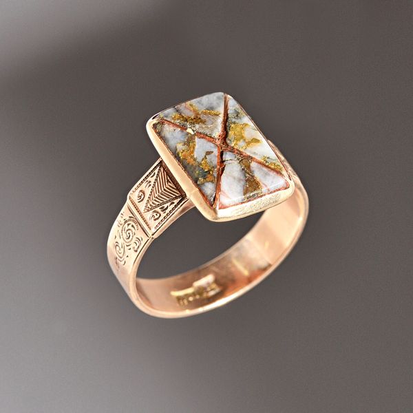 A gold mounted native gold in quartz panel shaped ring, of rectangular form, with engraved decoration to the shoulders, detailed 14K, probably America