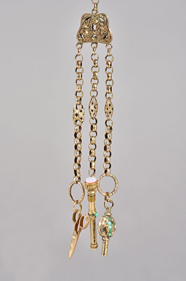 A Victorian gold chatelaine, with a floral and foliate pierced and engraved central division, fitted with a Victorian turquoise set watch key, a Victo