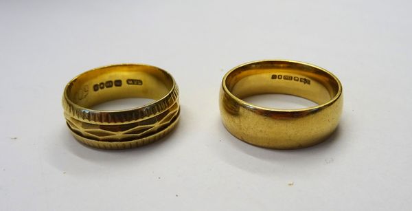 An 18ct gold decorated wedding band, London 1963, ring size L and a half and an 18ct gold plain wedding band, London 1988, ring size N and a half, com