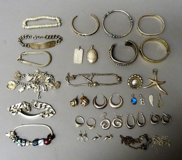 Silver and other jewellery, comprising; a charm bracelet, five further bracelets, a silver gilt bangle, four further bangles, seven pairs of earrings,