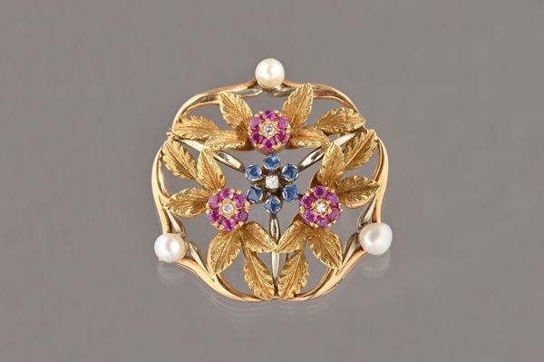 A gold, diamond, sapphire, ruby and cultured pearl set brooch, in a pierced foliate design, mounted with a central sapphire and diamond cluster, in a