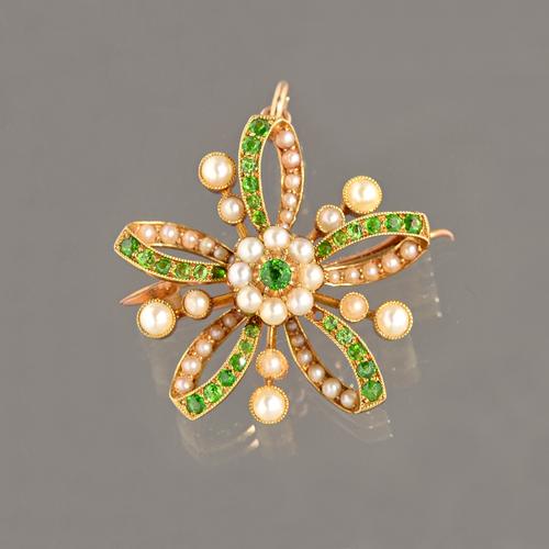 A gold, demantoid garnet and seed pearl set pendant brooch, in a curved cinquefoil design, with a cluster at the centre, detailed 15 CT, gross weight
