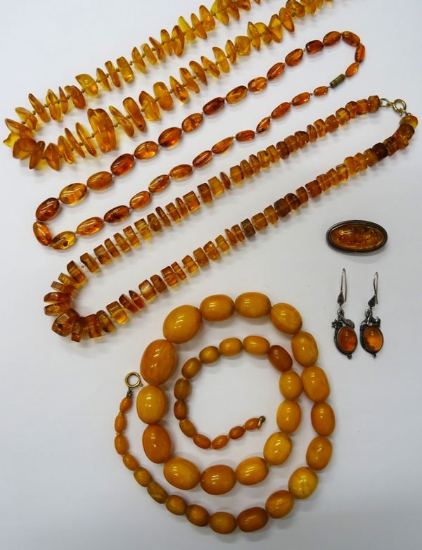 A single row necklace of mottled oval butterscotch coloured graduated amber beads, on a boltring clasp, length 64cm, gross weight 63 gms,  three recon