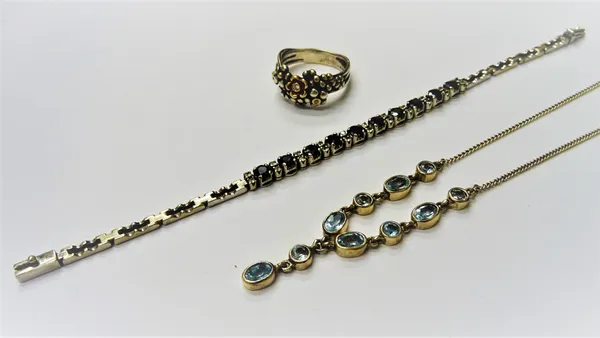 A silver and blue topaz necklace, detailed 925, a silver, gilt and diamond set ring, with two flowerhead motifs, each centred by a circular cut diamon