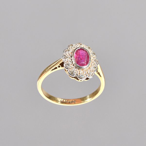 A gold, ruby and diamond oval cluster ring, collet set with the oval cut ruby at the centre, in a surround of circular cut diamonds, detailed 18 CT &