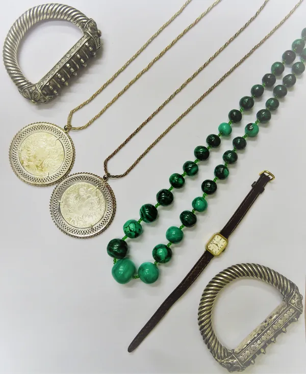 A pair of Middle Eastern bangles, each of 'D' section ropetwist form, an Omega gilt metal fronted lady's wristwatch, two re-struck Maria Theresia doll