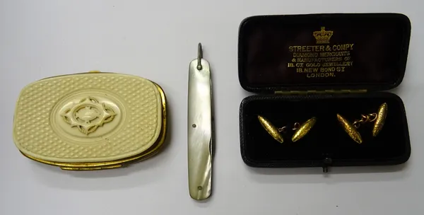 A pair of gold cufflinks, with torpedo shaped backs and fronts, having a beaten finish, apparently unmarked,  with a case, a simulated ivory veneered