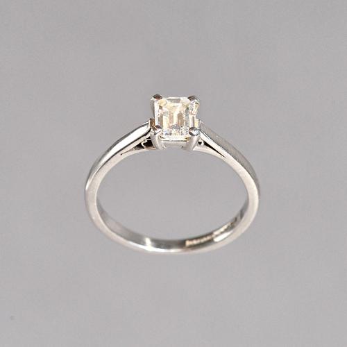 A platinum and diamond single stone ring, claw set with a cut cornered rectangular emerald cut diamond, ring size I, the diamond weighs approx 0.52 ct