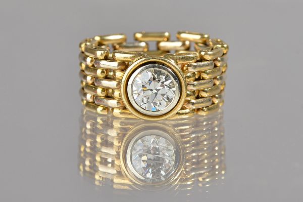A gold and diamond single stone ring, in a multiple row chain link design, collet set with a circular cut diamond, detailed 750, the diamond weighs ap