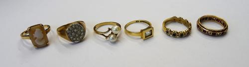 A gold ring, mounted with a shell cameo, designed as the portrait of a lady, detailed 9 CT, a gold, red and colourless gem set full eternity ring, det