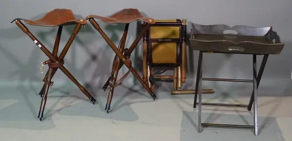 Shooting interest, including; a group of three leather and hardwood folding gun stools and a folding hardwood tray table, 54cm wide x 62cm high.   F9