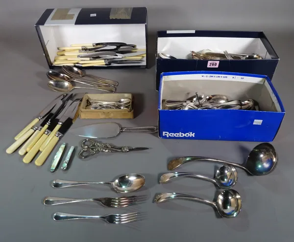 A quantity of plated table flatware, including knives, forks and spoons, a soup ladle, condiment spoons, two pocket knives, a pair of grape scissors a