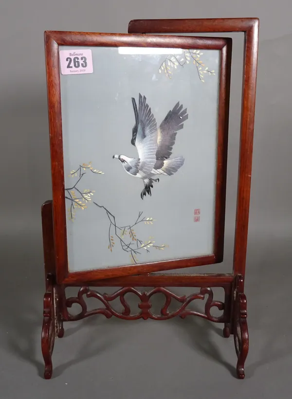 A 20th century Chinese silk work picture, depicting an eagle in flight, within a hardwood stand, 23cm wide x 38cm high.  CAB
