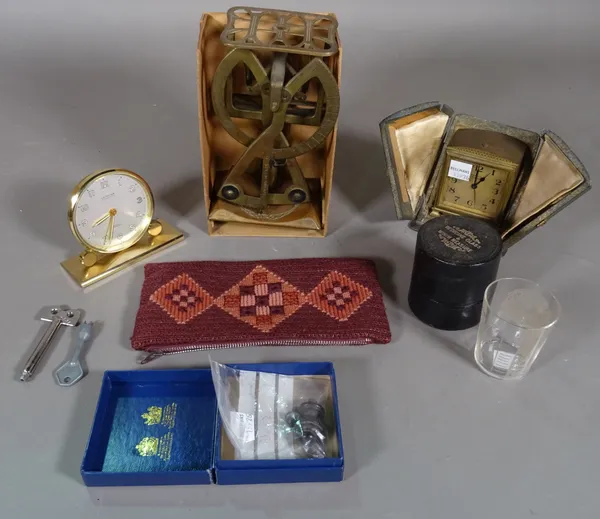 A Zenith travelling alarm clock, with a folding case, a Looping alarm clock, a brass set of letter scales and a medicine glass. CAB