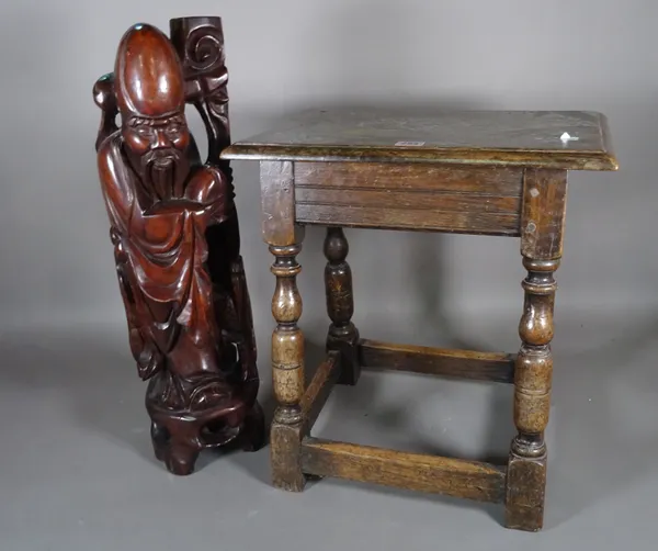 An 18th century and later oak joint stool, 45cm wide x 47cm high and a Japanese hardwood figure, 65cm high.  H5