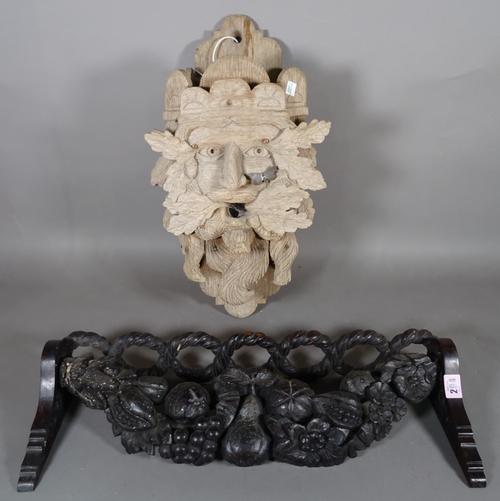 An 18th century and later oak wall mounted stick stand with carved fruit decoration, 58cm wide and an early 20th century hardwood bird box, formed as