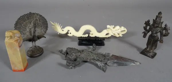 Asian collectables; comprising, an Indian white metal model of a peacock, a bronze model of a deity, an Asian figural dagger, a soapstone seal and sun