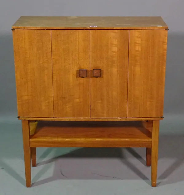 A 20th century teak side cabinet, with fitted interior on tapering supports, 68cm wide x 80cm high.  G8