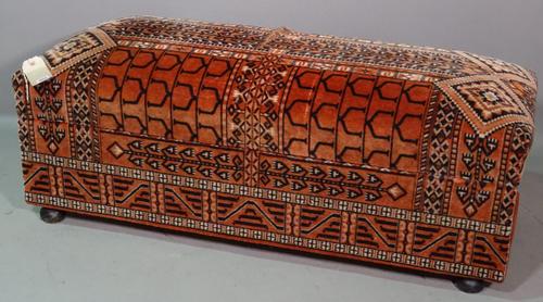 An early 20th century pine framed rectangular ottoman, with overstuffed seat on bun feet, 125cm wide x 45cm high.   I10