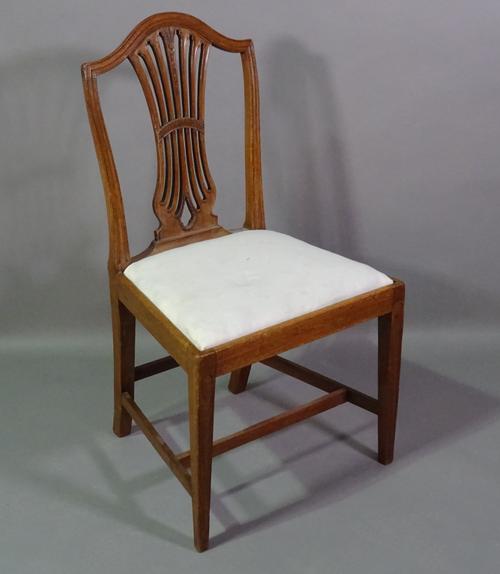 A George III mahogany shield back hall chair on tapering supports.   C7