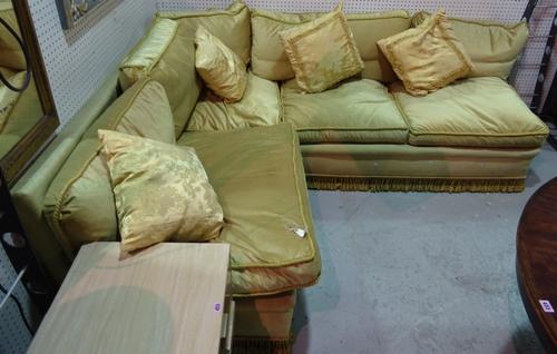 An early 20th century mahogany framed corner sofa with green upholstery on tapering supports, 170cm wide.  A10