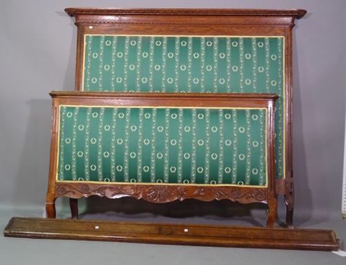 An early 20th century oak framed double bed with cushion framed head and foot board, 170cm wide x 138cm high.    I10