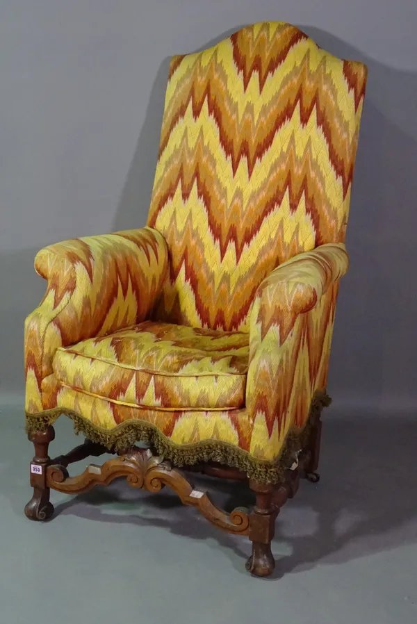 A 19th century mahogany framed highback armchair on turned 'H' frame stretcher.   G10