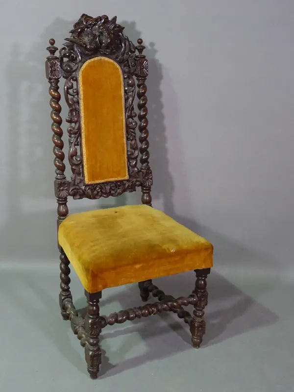 An 18th century oak highback chair on spiral twisted supports and carved ho ho bird crest.   E10