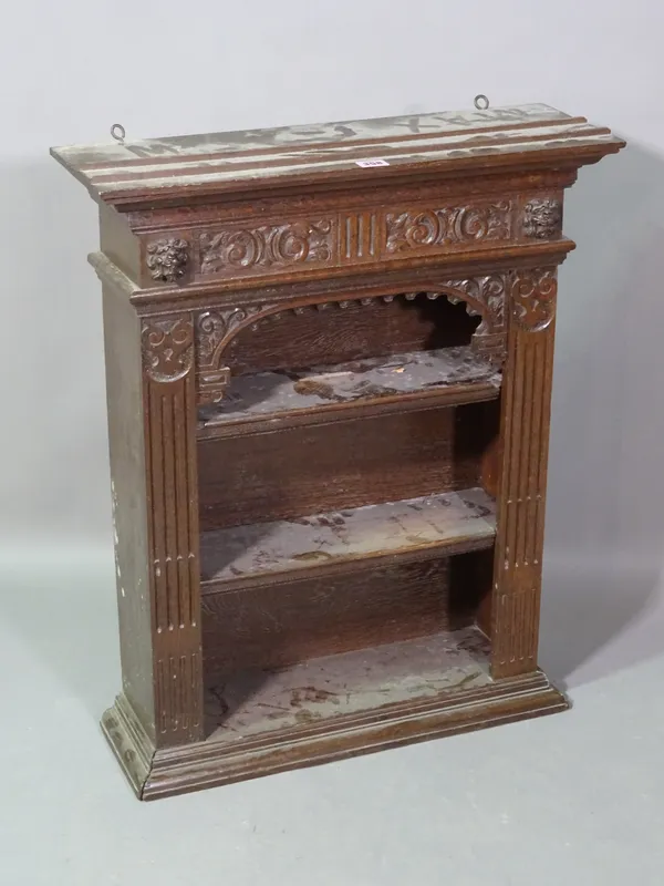 An 18th century style oak hanging bookcase with carved decoration, 60cm wide x 73cm high.   D6