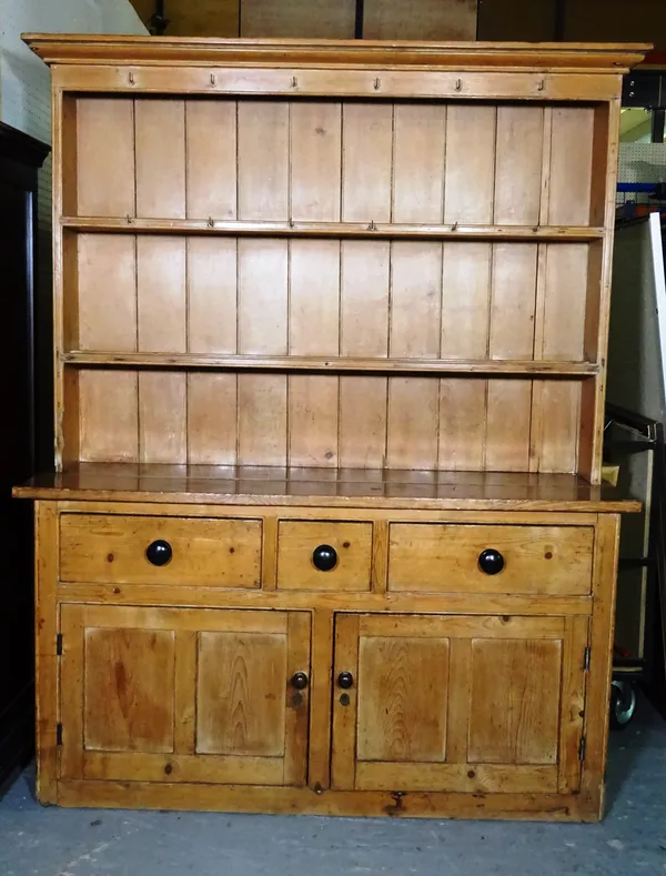 An early 20th century pine dresser with three tier plate rack over three drawer cupboard base, 151cm wide x 190cm high.   M10