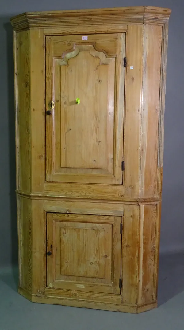 An early 20th century pine corner cupboard with panelled doors, 103cm x 186cm high.   G10