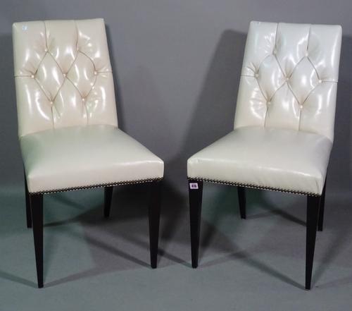 Baker; a set of seven 20th century dining chairs with white leather button back upholstery, (7).  BAY 2