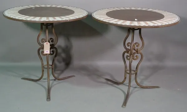 A pair of 20th century wrought iron and stone circular garden tables on outswept supports, 80cm wide x 79cm high.   H9