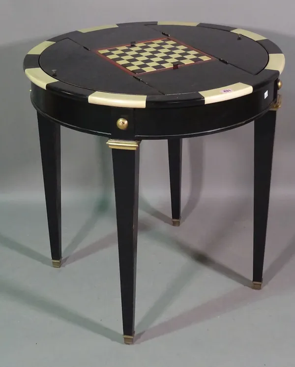 A 20th century ebonised circular games table on tapering square supports, 74cm wide x 78cm high.   J7