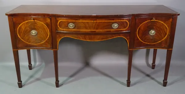 A George III style serpentine mahogany sideboard on tapering spaded supports, 181cm wide x 89cm high.   C5