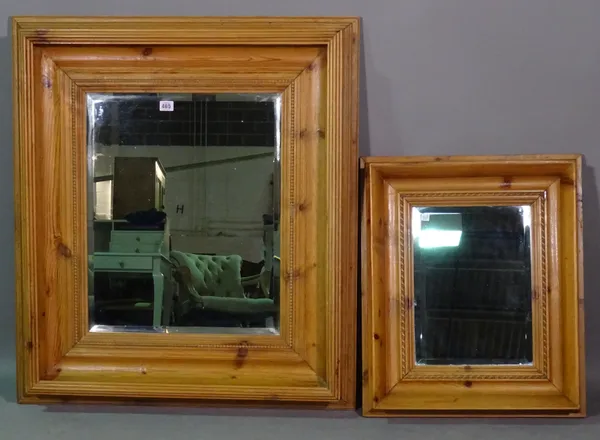 A 20th century pitch pine framed mirror with split beading border decoration, 81cm wide x 95cm high and another smaller, 52cm wide x 62cm high, (2).