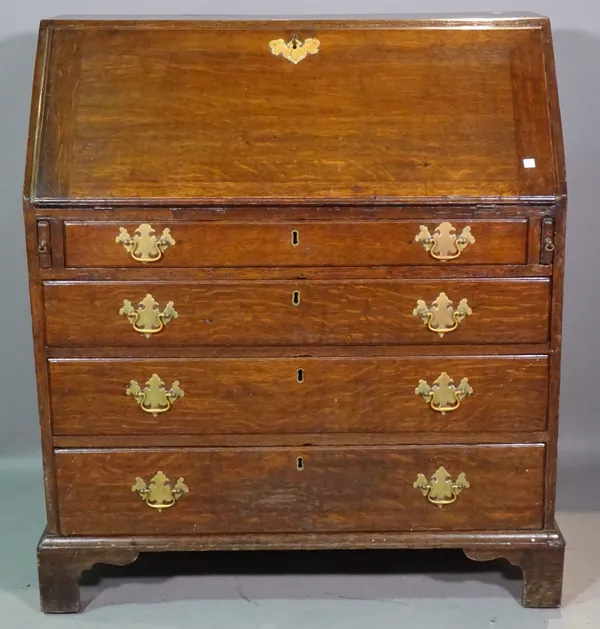 A George III oak bureau with fitted interior over four long graduated drawers, on bracket feet, 94cm wide x 107cm high.    H7