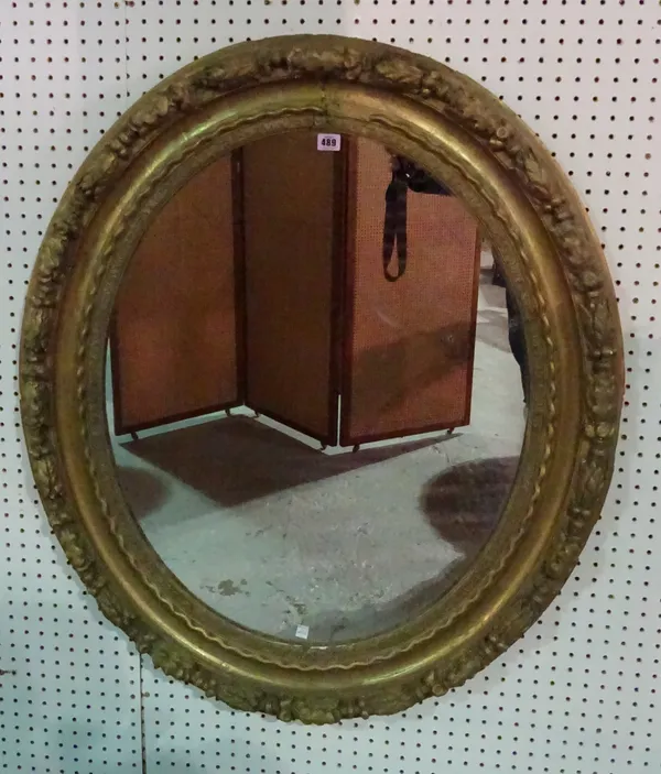 An early 19th century French gilt framed oval mirror, with floral leaf decoration, 80cm wide x 108cm high  J10