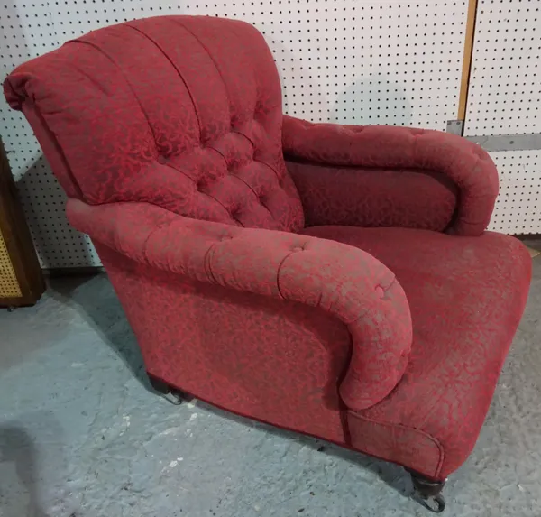A mid-Victorian easy armchair with button back and overstuffed arms on turned supports, 78cm wide x 84cm high.  J5