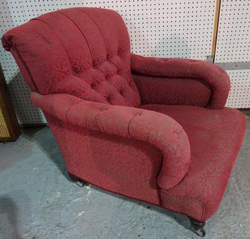 A mid-Victorian easy armchair with button back and overstuffed arms on turned supports, 78cm wide x 84cm high.  J5