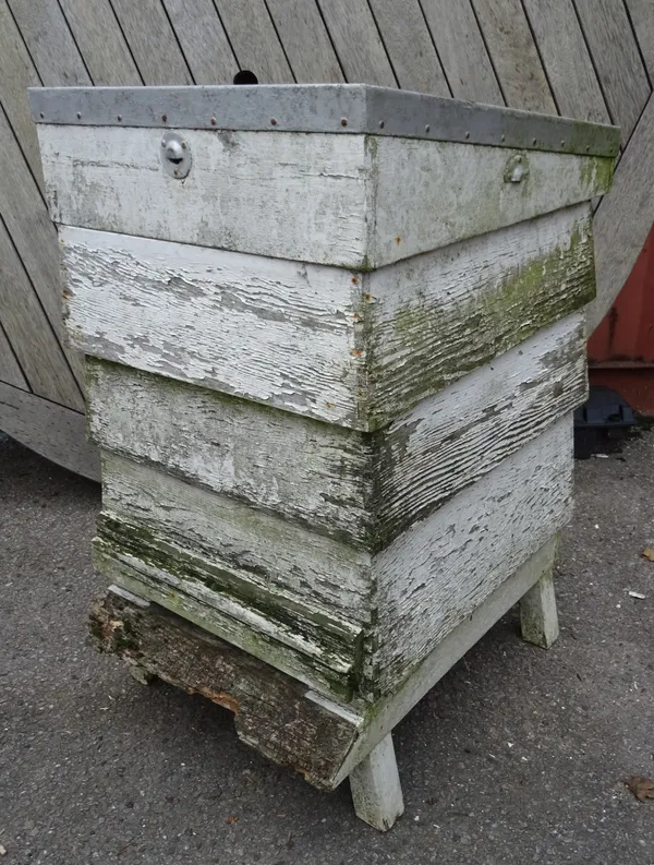 An early 20th century white painted bee hive, 50cm wide x 100cm high (weathered).  OUT