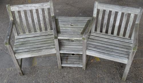 A 20th century hardwood garden bench, with three tier integral middle section, 160cm wide.  OUT