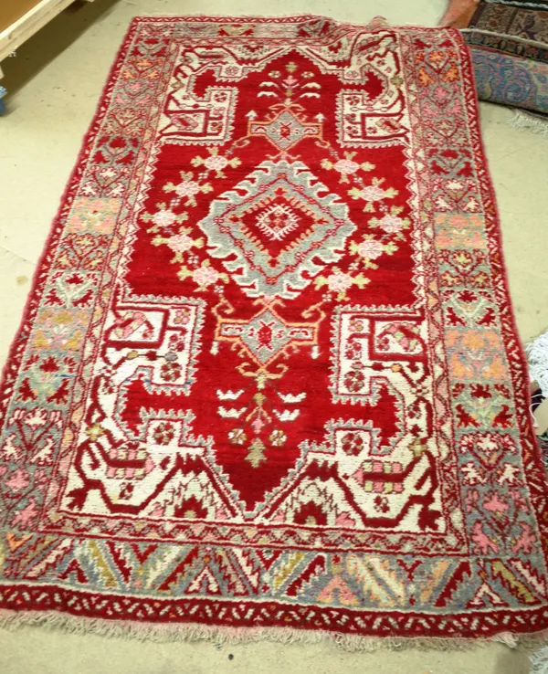 A red ground decorative rug possibly Turkish 210cm x 127cm.   BAY 1 4854