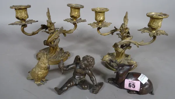 Metalware collectables, including; a pair of acanthus moulded twin branch candlesticks, a gilt metal model of a bird, a cherub and a deer.  CAB