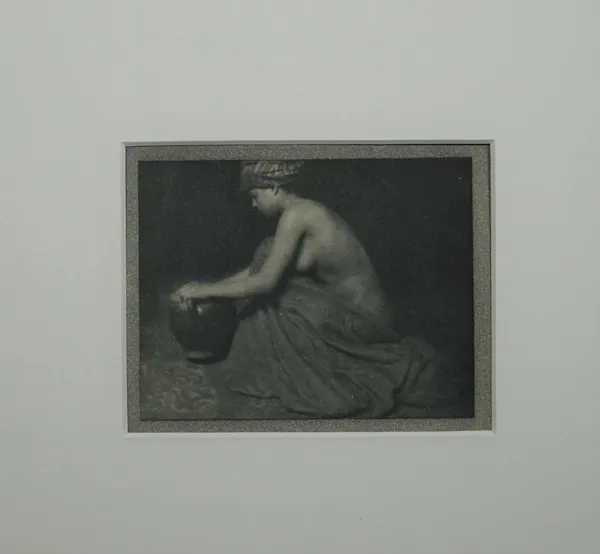 ALVIN LANGDON COBURN  (1882 - 1966)  The Water Carrier, 1913.  photogravure of a woman kneeling with an urn, ca. 1913, inscribed within the book plate