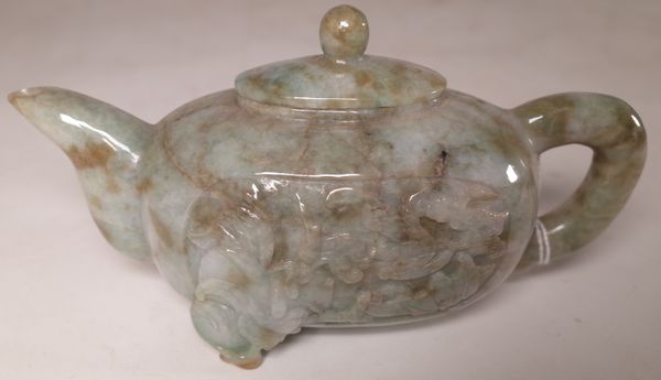 A Chinese jade oval teapot and cover, 20th century, carved with bats, lotus flowers and a peach, 16.5cm. length, (2).