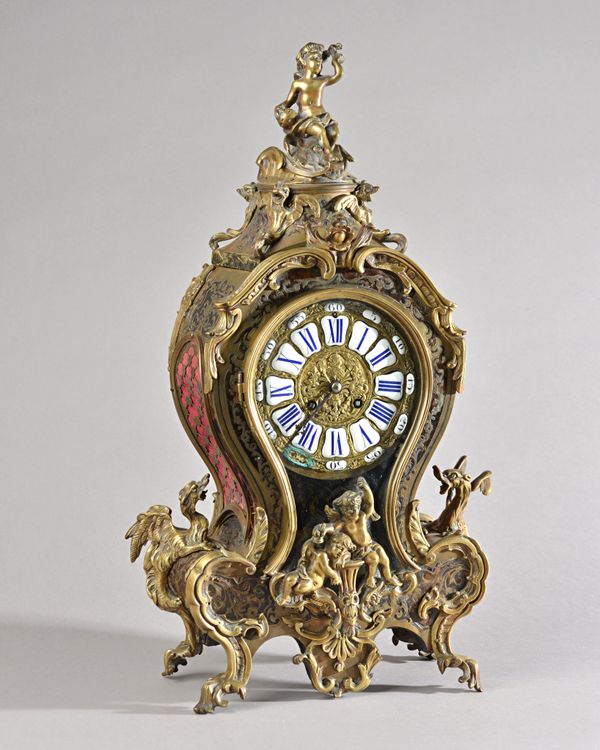 A Louis XV style boulle work bracket clock of waisted form, with cherub finial, enamelled Roman numerals, glazed pendulum aperture and a French two tr